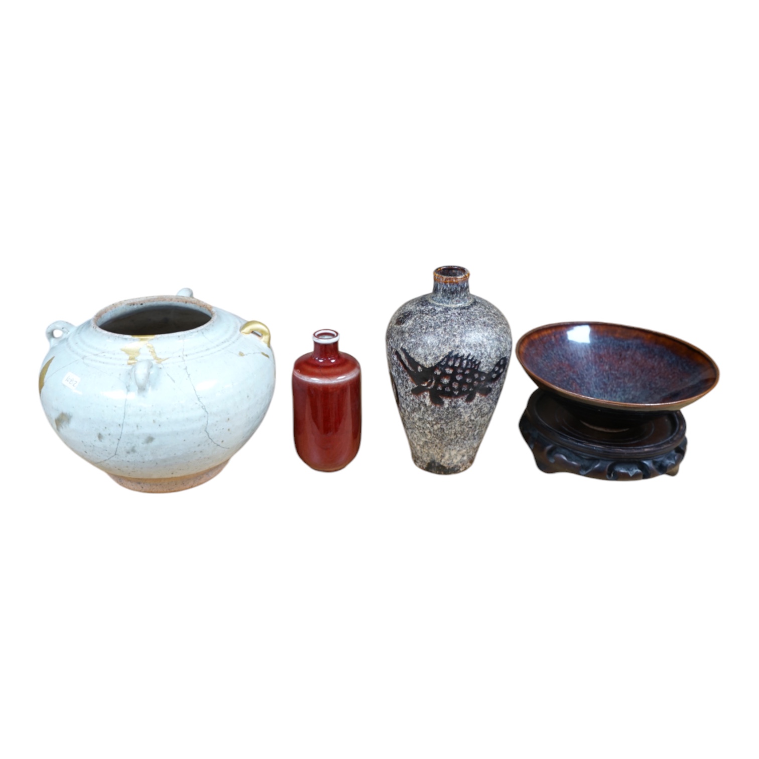 Chinese ceramics comprising a white glazed jar, Jin-Yuan dynasty, hare’s fur type bowl, a cut paper silhouette vase and a sang de boeuf glazed vase, largest 17cm in diameter (4). Condition - poor to good